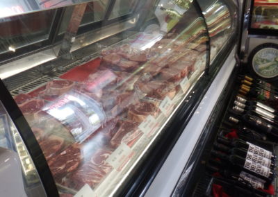 meat in deli case and wine displayed at Destin Ice