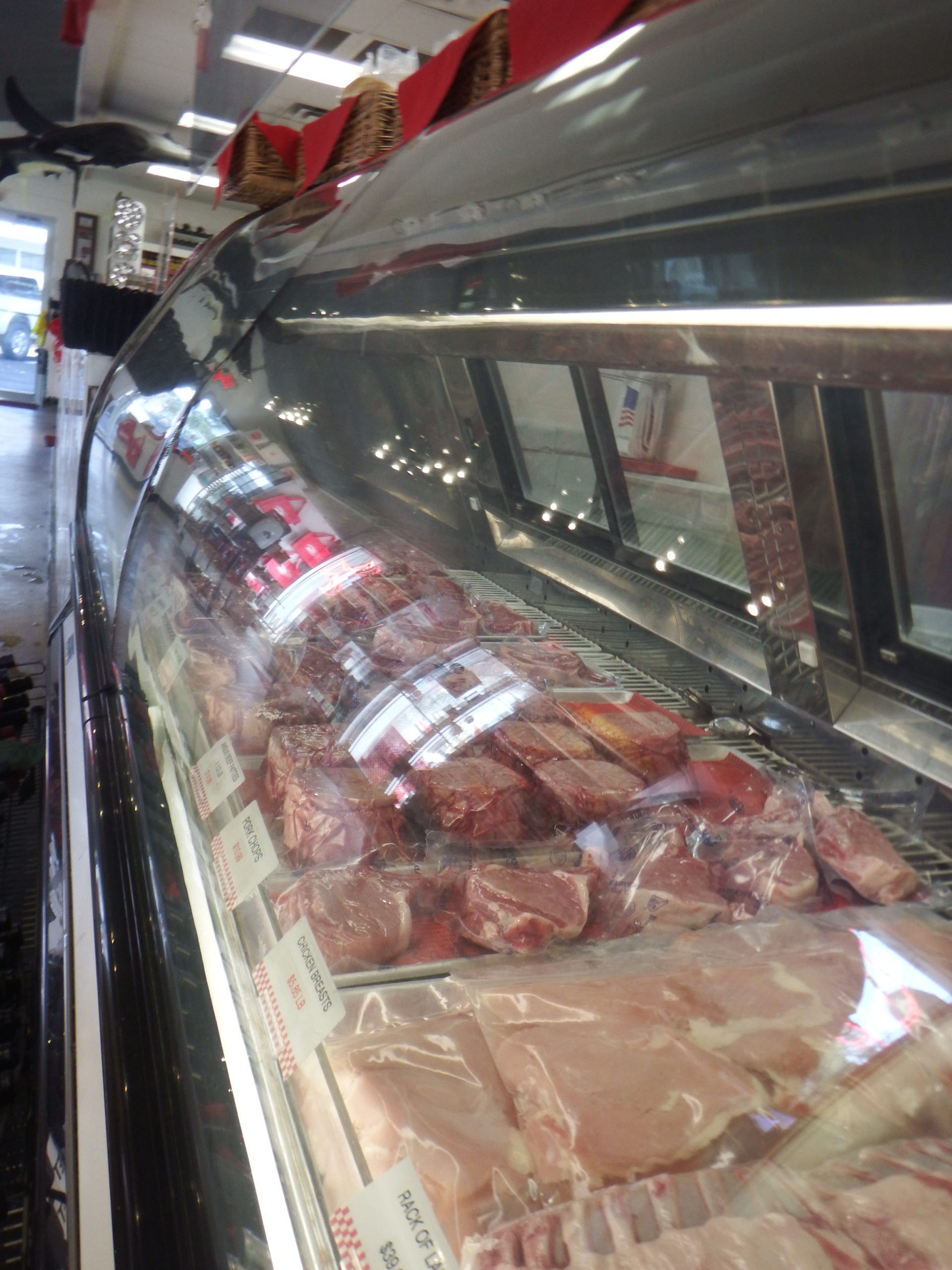 beef, pork and chicken in refrigerator at Destin Ice