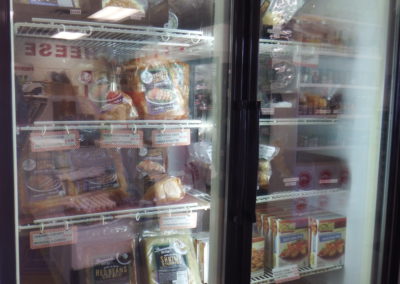 refrigerator at Destin Ice Seafood filled with prepared and ready to cook meals