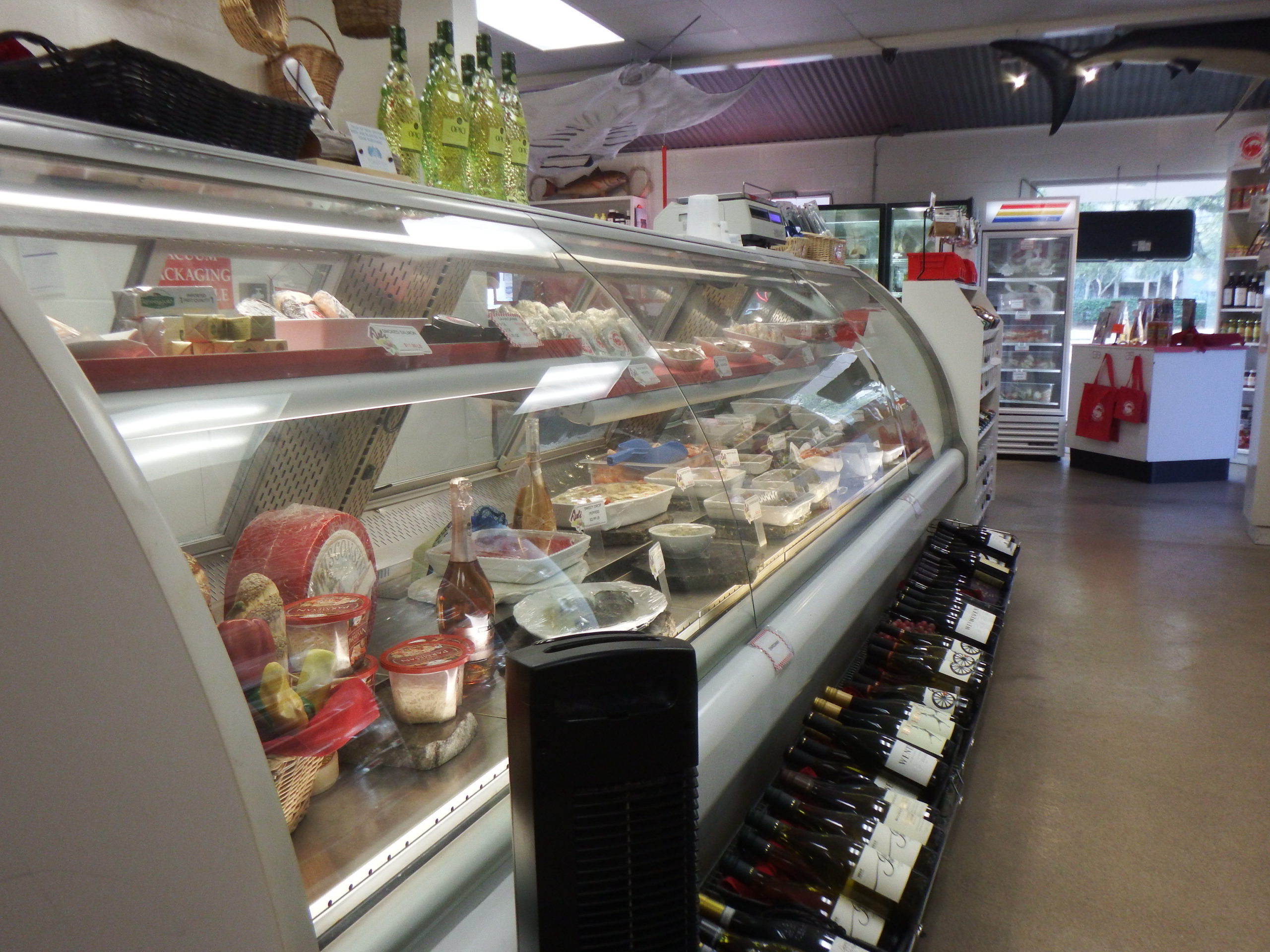 prepared foods in deli case with wine display at Destin Ice Seafood Market