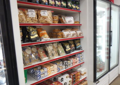 shelf with crackers and chips for sale at Destin Ice Seafood Market