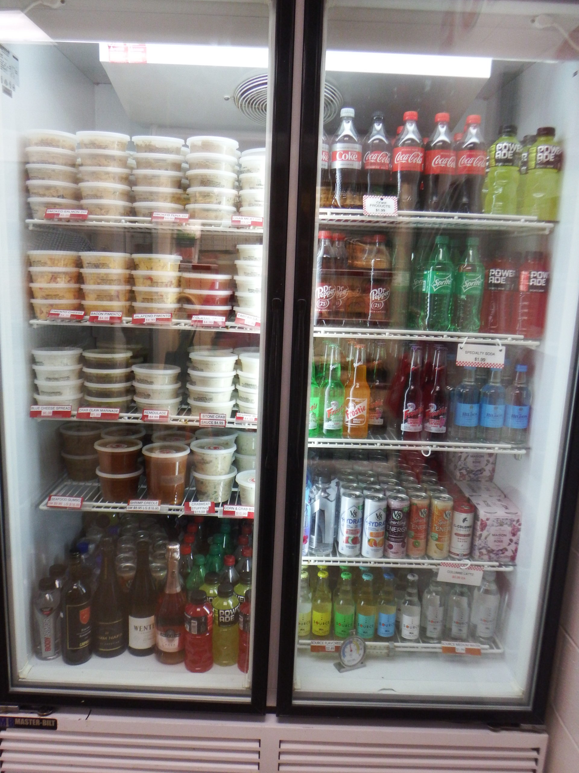 refrigerator with drinks and seafood soups, dips and spreads